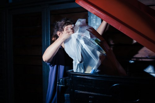 Technician handling electronic waste during office clearance in Downham