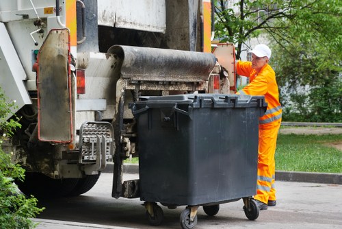 Construction workers loading materials into a skip