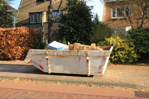 Customer loading waste into a skip